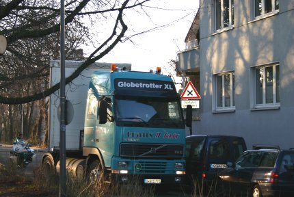 Der Motorradpolizist schreibt bereits das Knöllchen: Der Baumstamm blockiert die Durchfahrt und die geparkten Autos lassen dem LKW keinen Spielraum zum weiteren Rangieren. Teuer wird es, weil der LKW-Fahrer bereits 200 Meter gegen die Einbahnstrasse gefahren ist, um bis zu dieser Stelle zu gelangen. 